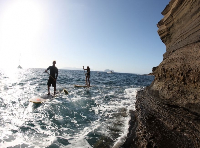 un couple pratiquant le paddle surf dans la mer